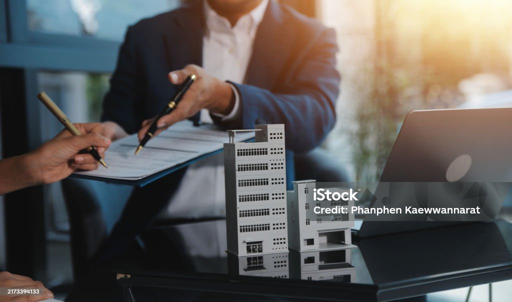 Real estate agent and customer signing contract to buy house, insurance or loan real estate.rent a house,get insurance or loan real estate or property.